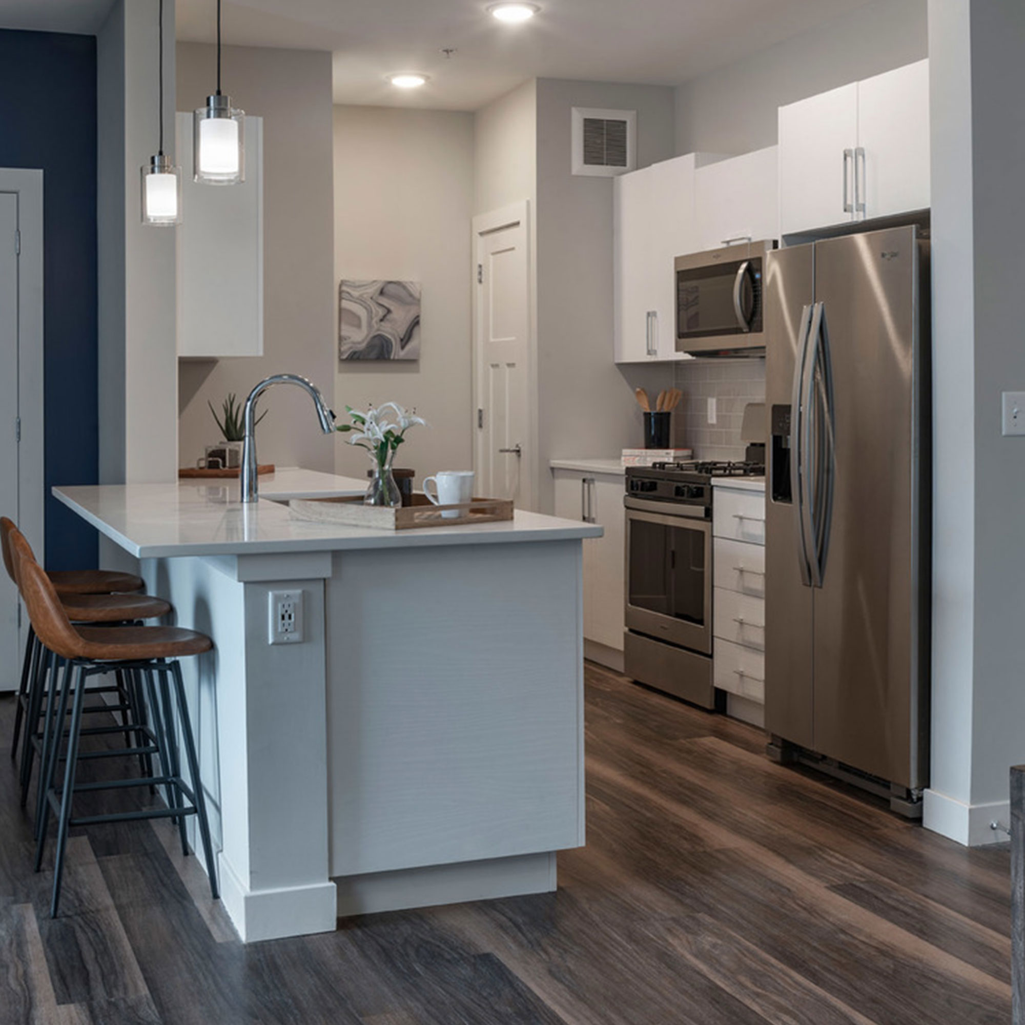 Kitchen with counter and seating at Halstead Maynard Crossing