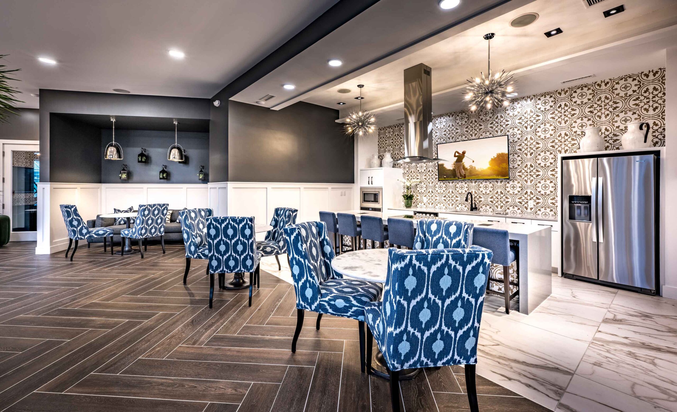 Communal lounge with tables and seating at Halstead Maynard Crossing
